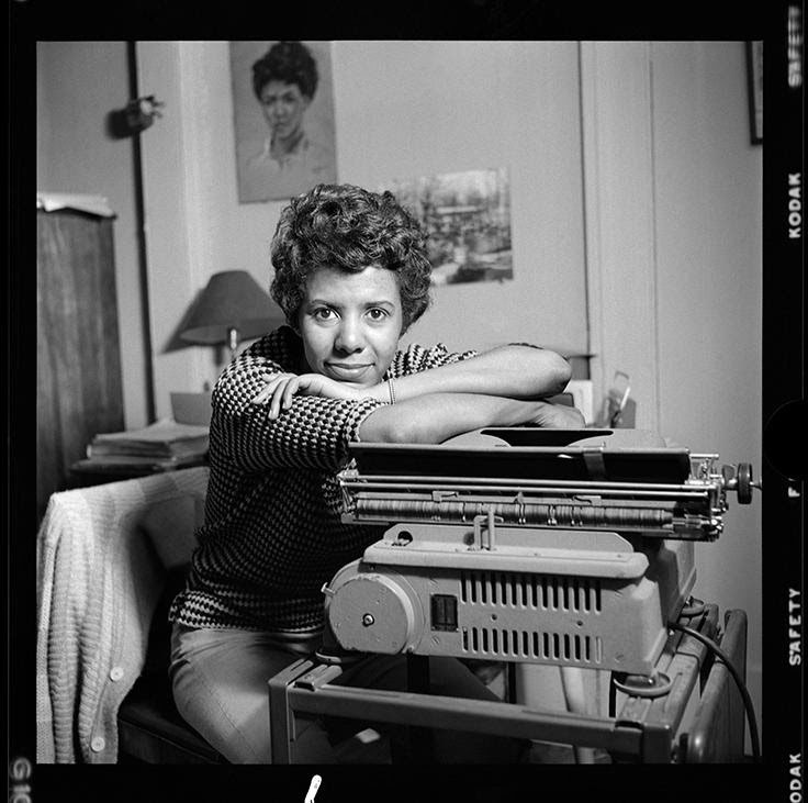 Lorraine Hansberry leans over her typewriter at her Greenwich Village apartment on Bleecker Street.